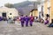 Three purple robbed men with incense smoker on the cobbled streets for the procession San Bartolome de Becerra, Antigua, Guatemala