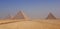 Three Pyramids of Giza at foggy morning