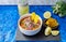 Three-quarter photo of an encebollado, a typical Ecuadorian meal prepared with fish, onion, lemon and yucca on a blue background.