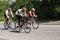 Three racing cyklists on a road bike during triathlon.