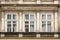 Three ragged Windows on the facade of the old house