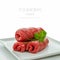Three raw roulades beef on white plate,