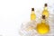 Three raw vegetable oils in a beautiful glass bottle on a white tablecloth and background  cedar  sunflower and olive