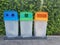 Three recycle bins in public place for collection of materials