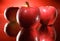 Three red apples background droplets