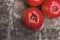 Three red apples on a wooden background. Fruit