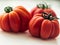 Three red beefsteak tomatoes.