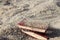 Three red books on the sand, covered with sand, concept of transience of time, blurred background.