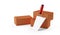 Three red brick stones with trowel standing in front on white background, construction or masonry or industry concept