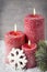 Three red candles on gray background, Christmas decoration. Advent mood.