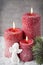 Three red candles on gray background, Christmas decoration. Advent mood.