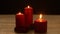 Three red candles light with roses romantic theme