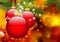 Three Red Christmas Balls hanging in front of Abstract Fir Tree