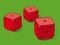 Three red dice on green