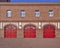 Three red doors and four windows, fire squad station, Germany