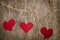 Three Red fabric hearts hanging on the clothesline