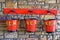 Three red fire buckets on the station platform on the Rowlew Train Station