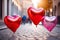Three red heart-shaped balloons on a stone street. Love, romance, Valentines Day concept
