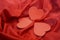 Three red hearts on red silk background with ripples