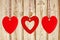 Three red hearts on the wooden weathered rustic