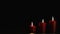 Three red mysteriously burning candle on a black background. Copy space.