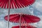 Three red parasols standing outside