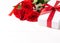 Three red roses, gift with red ribbon on the white wooden background. Women`s day, mother day, valentines day, happy birthday