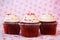 Three red velvet cupcakes