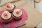 Three red velvet cupcakes on colorful paperbag