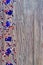 three red, white and blue Australian flags suspended from a twine rope in front of a grungy, steel background for Australia Day on