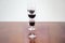 Three red wine glasses of different sizes aligned in selective focus with depth of field blur .