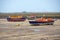 Three `retired` vintage British Lifeboats at low tide.