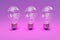 three retro style lightbulbs with glowing filament standing in a row on infinite colorful background creativity design concept