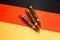 Three rifle cartridges on the flag of Germany. Close-up, copy space