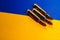 Three rifle cartridges on the flag of Ukraine. Close-up, copy space