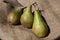 Three ripe pears on the jute bag