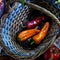 Three ripe peppers are in the basket