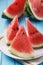 Three ripe pieces of watermelon on a wooden table