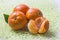 Three ripe round orange tangerines with a gutted Mandarin