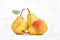 Three ripe yellow skinned pears, slightly imperfect fresh organic beautiful studio shot Bartlett pear with stem and green leaf