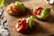 Three roasted tomato bruschetta with tomatoes olive oil  anchovy oregano and basil