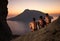 Three rock climbers having rest at sunset