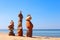 Three Rock zen pyramids of colorful pebbles standing on the beach, on the background of the sea. Concept of balance, harmony and m