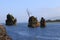 Three rocky outcroppings in a bay on the Pacific ocean