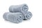 Three rolled gray towels on white
