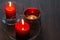 Three romantic candles on a wooden background. Home decor items. The light of the fire of paraffin candles