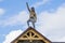 three Roofer man roof carpenter working Country house renovation. looking at camera blue sky beautiful clouds, unfinished wall