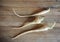 Three roots of parsnips on a wooden cutting board