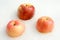 Three rosy apples on the white snow