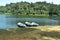 Three roving boat on forest lake side